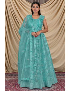 Woman wearing a sea green traditional outfit with a matching dupatta