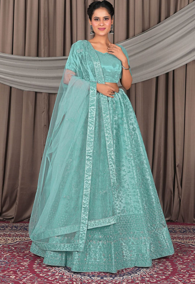 Woman wearing a light blue traditional outfit with a matching dupatta
