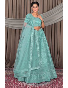 Woman wearing a light blue traditional outfit with a matching dupatta