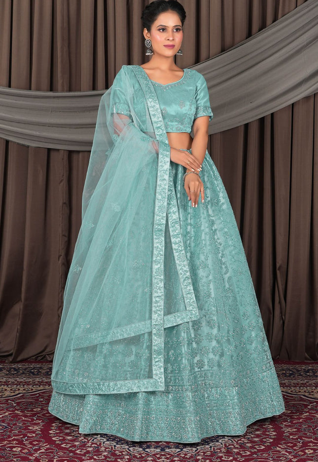 Woman wearing a light blue traditional outfit with a matching dupatta