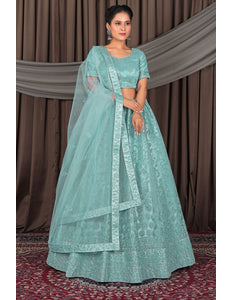 Woman wearing a light blue traditional outfit with a matching dupatta