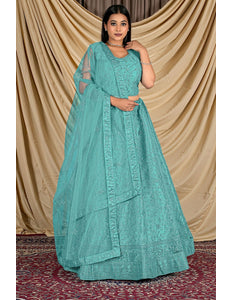 Woman wearing a teal traditional outfit with a matching dupatta