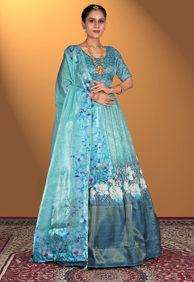 Woman wearing a sea green floral dress with a matching dupatta
