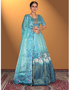 Woman wearing a sea green floral dress with a matching dupatta