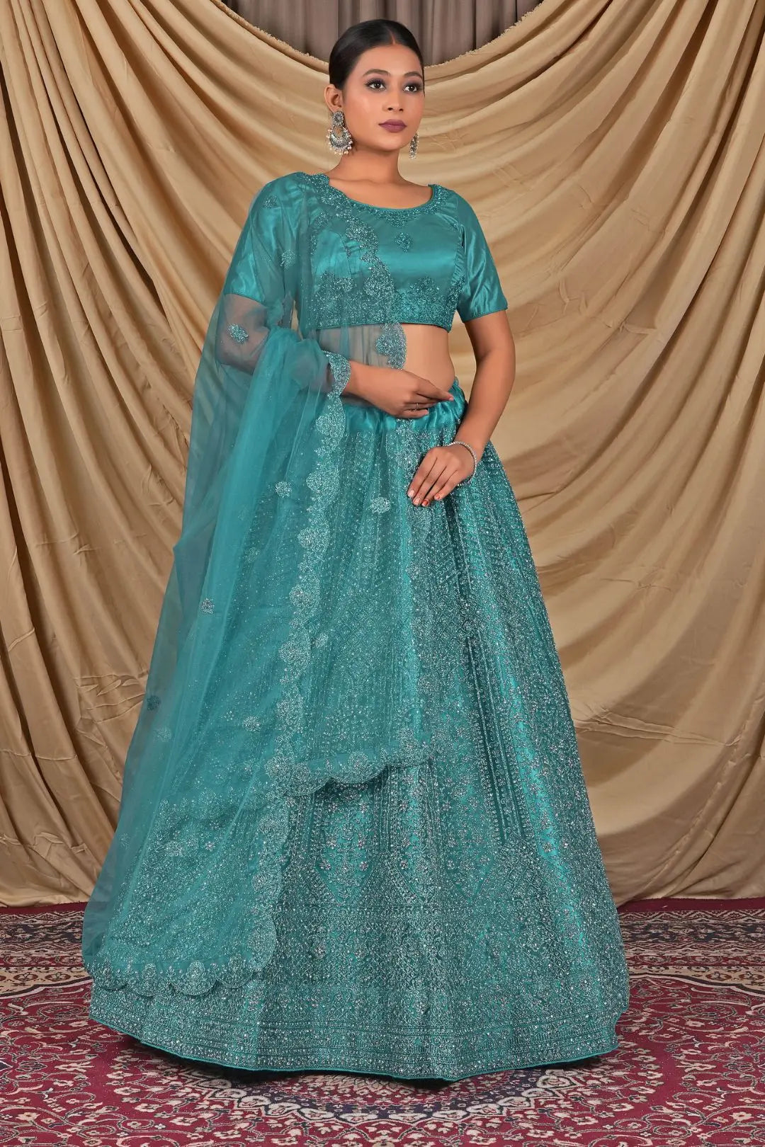 Teal embroidered traditional outfit with a matching dupatta and blouse