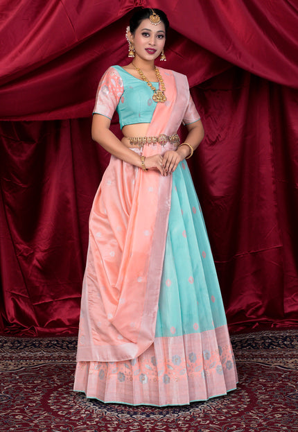 Woman wearing a traditional outfit with a pink and light blue lehenga choli