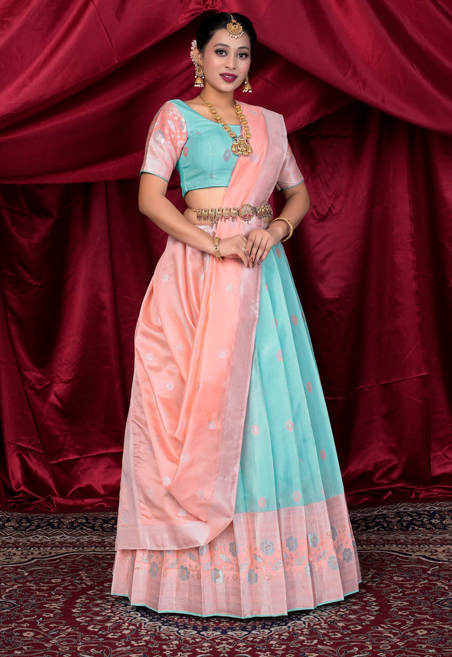 Woman wearing a traditional outfit with a pink and light blue lehenga choli