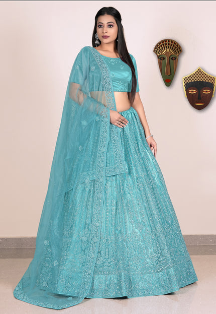 Woman wearing a teal embroidered lehenga with blouse