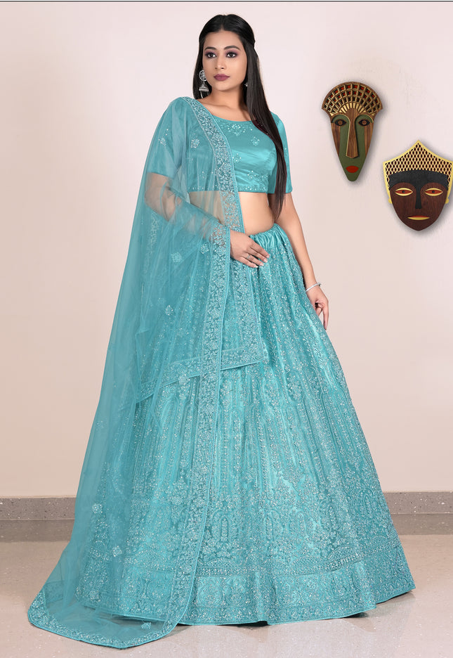 Woman wearing a teal embroidered lehenga with blouse
