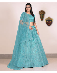 Woman wearing a teal embroidered lehenga with blouse
