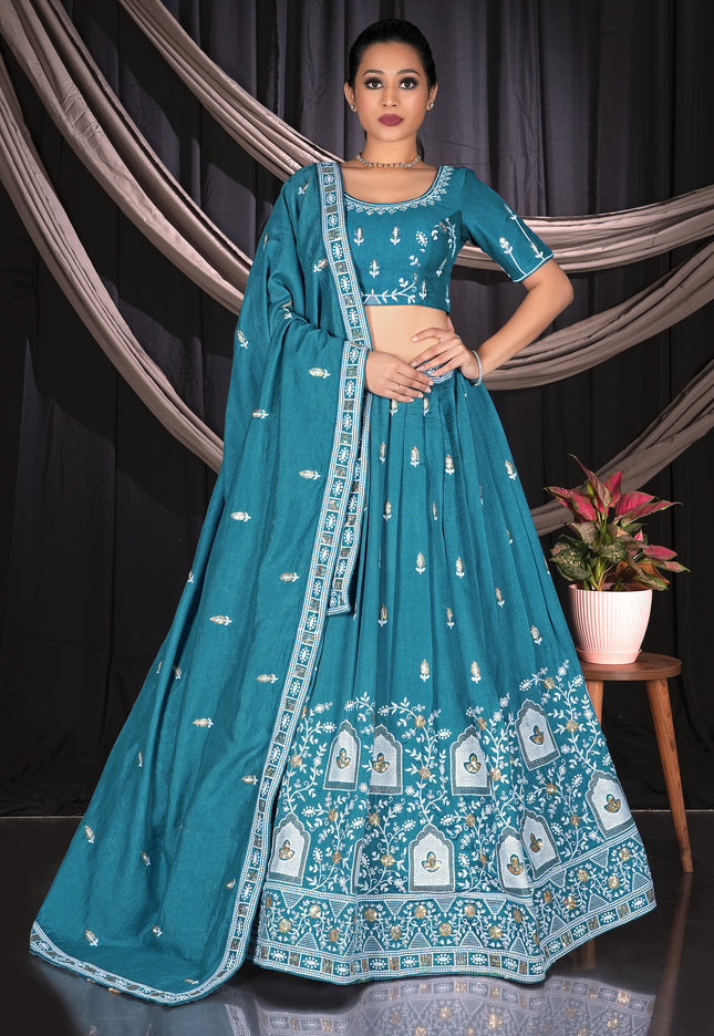 Woman wearing a teal embroidered traditional lehenga