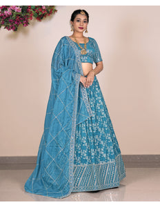Woman wearing a blue embroidered with matching blouse