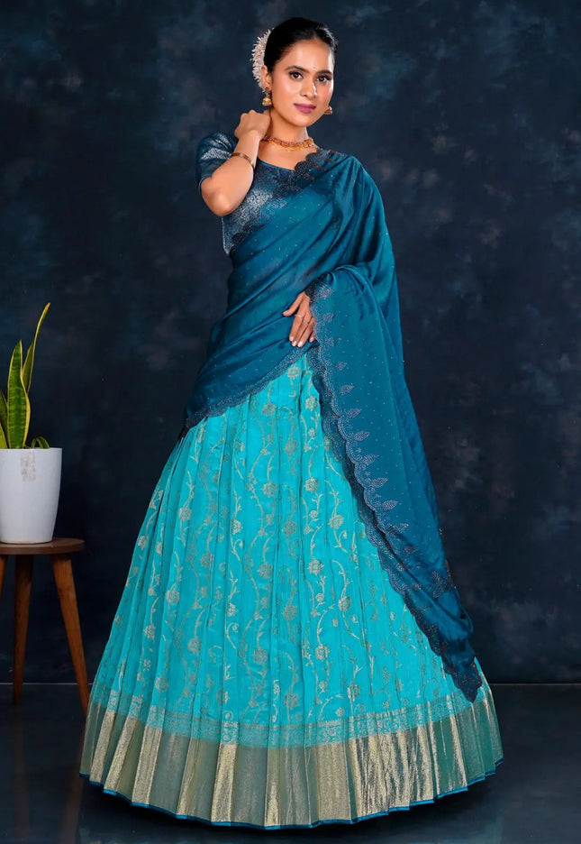 Woman wearing a blue lehenga choli with contrast dupatta
