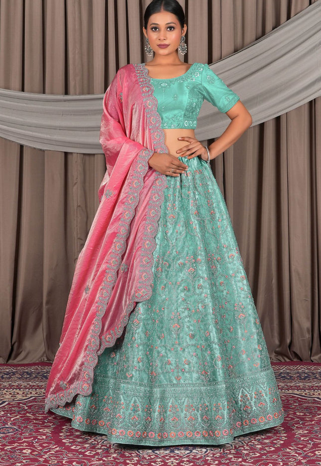 Traditional outfit with a green and pink lehenga choli with dupatta