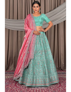 Traditional outfit with a green and pink lehenga choli with dupatta