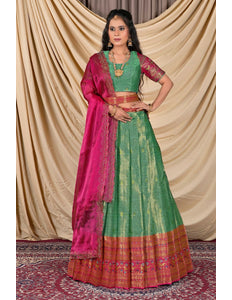 Woman wearing a green and pink traditional outfit