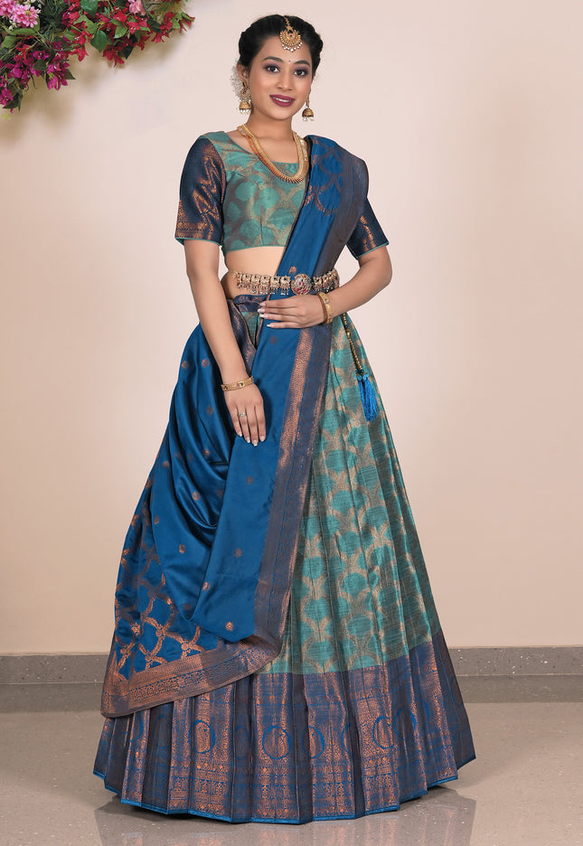 Woman wearing a blue and green lehenga with a matching blouse