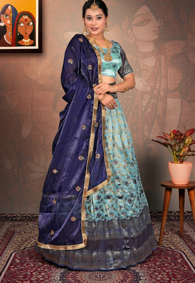 Woman in a traditional blue and green lehenga choli with dupatta