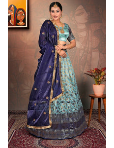Woman in a traditional blue and green lehenga choli with dupatta