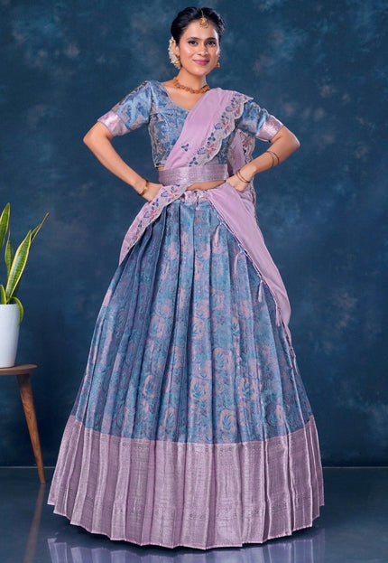 Woman wearing a traditional blue and pink lehenga choli with dupatta