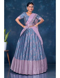 Woman wearing a traditional blue and pink lehenga choli with dupatta