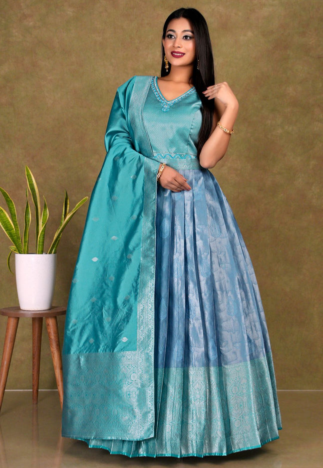 Woman wearing a teal and blue traditional gown with dupatta