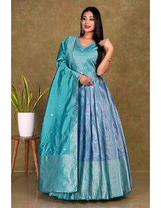 Woman wearing a teal and blue traditional gown with dupatta