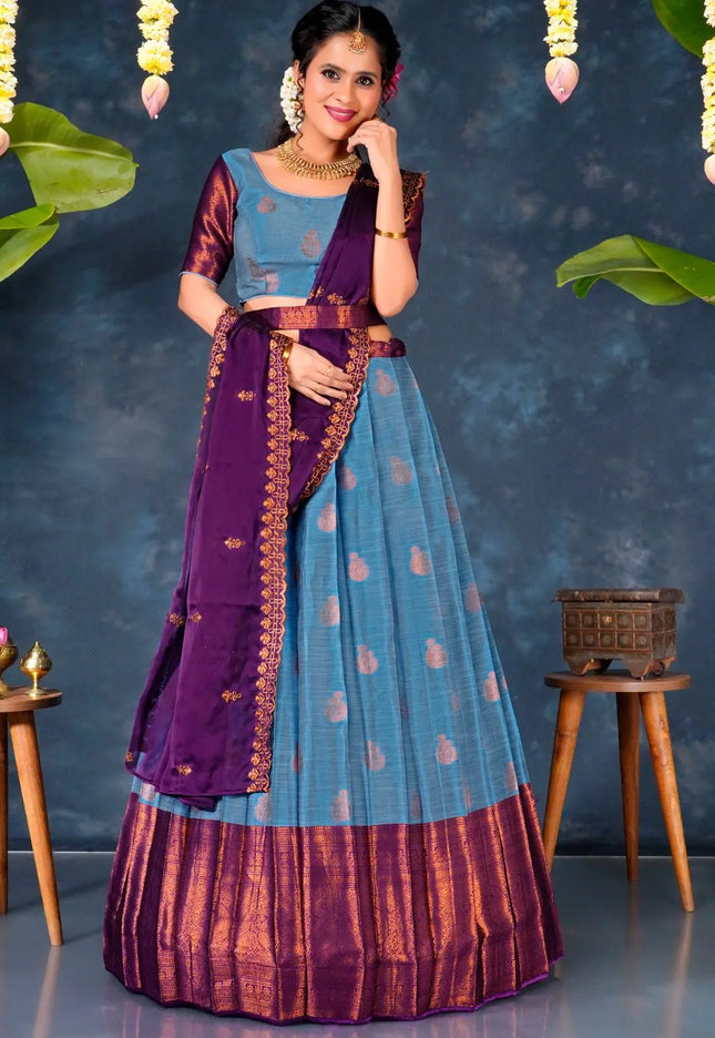 Woman in a traditional sky blue and purple lehenga choli with dupatta