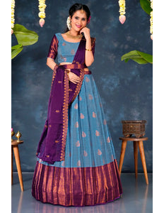Woman in a traditional sky blue and purple lehenga choli with dupatta