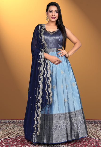 Woman wearing a sky blue traditional outfit with a blue dupatta
