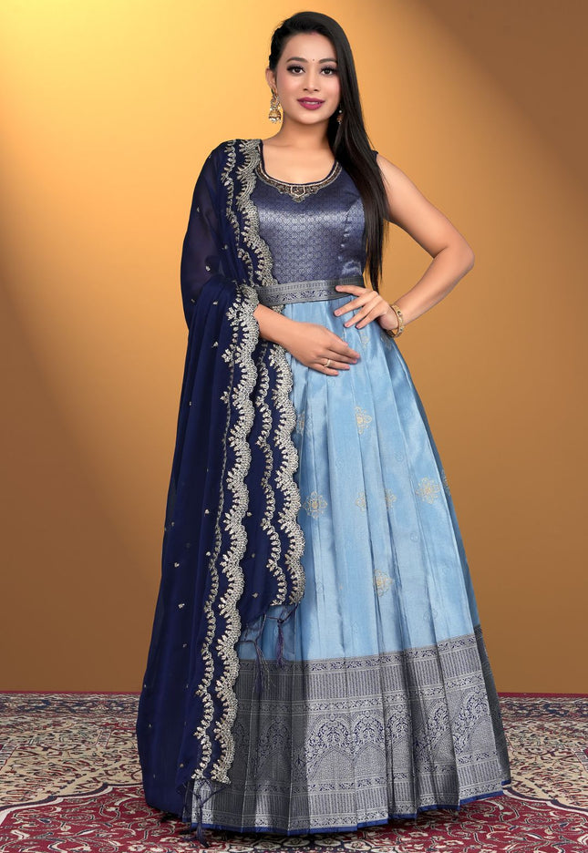 Woman wearing a sky blue traditional outfit with a blue dupatta