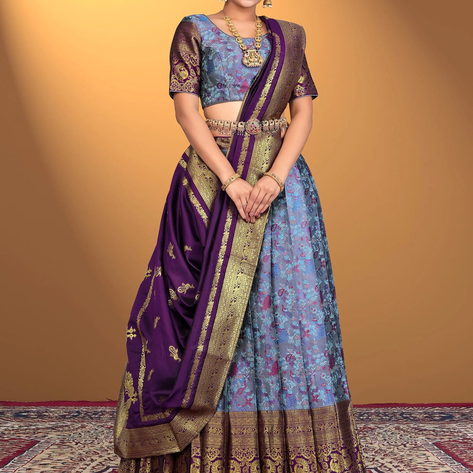 Woman wearing a traditional lehenga choli with a purple and blue color