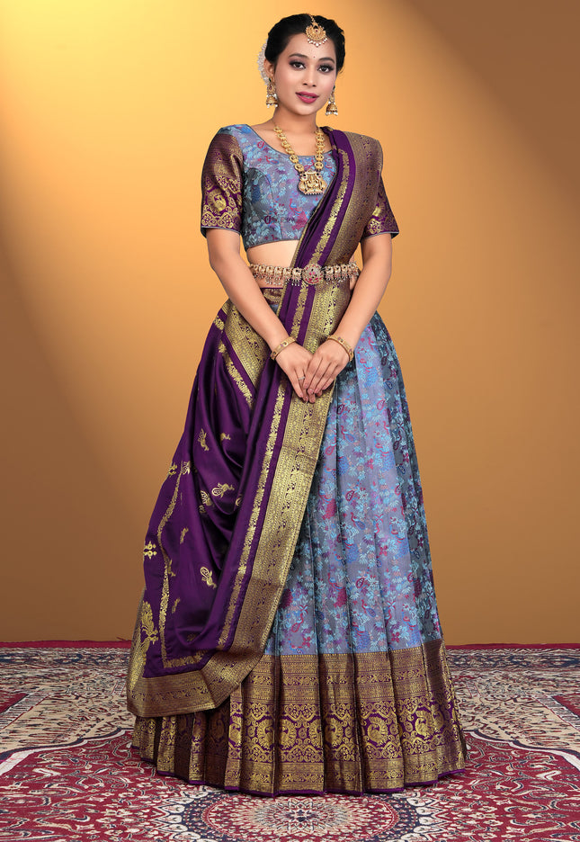 Woman wearing a traditional lehenga choli with a purple and blue color