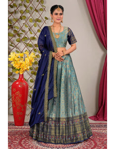 Woman wearing a traditional blue and green lehenga choli with dupatta