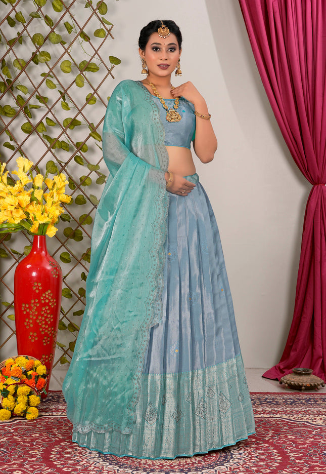 Woman in a light blue lehenga choli with dupatta