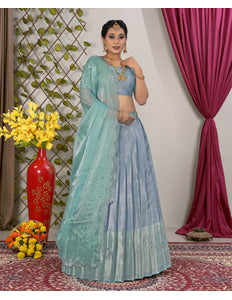 Woman in a light blue lehenga choli with dupatta