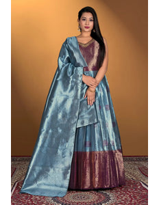 Woman wearing a traditional outfit with a blue gown with matching dupatta