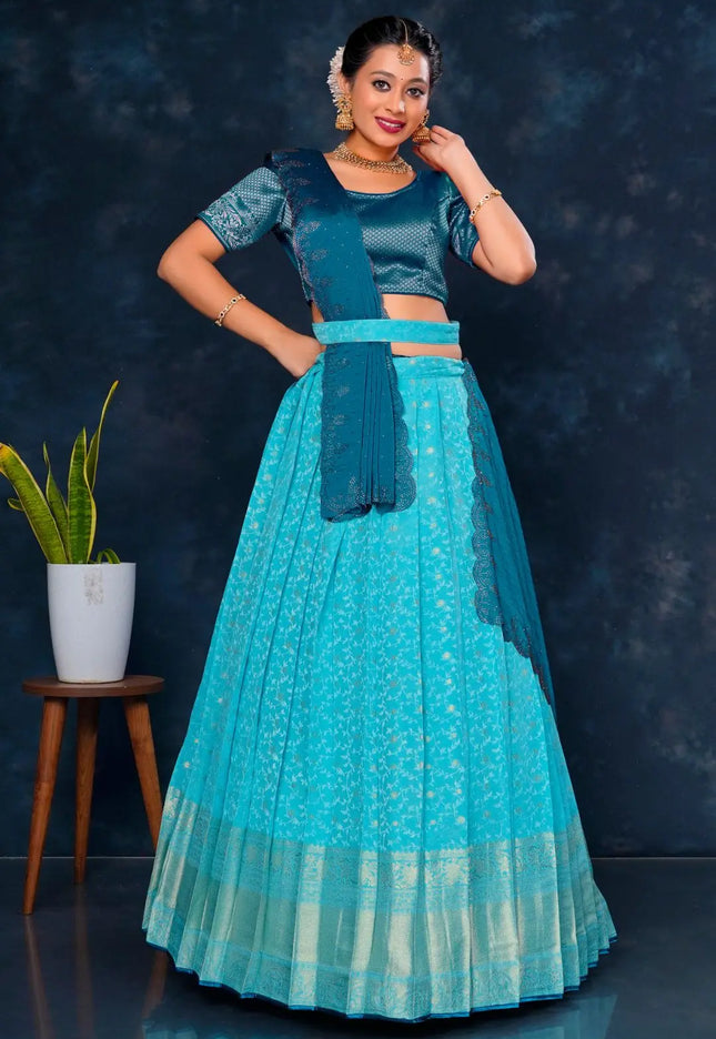 Woman in a teal traditional lehenga choli with dupatta