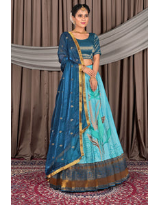 Woman wearing a traditional blue outfit with gold accents
