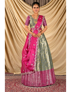 Woman wearing a traditional pink and green lehenga choli with dupatta