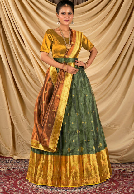 Woman wearing a traditional green and gold lehenga choli with dupatta
