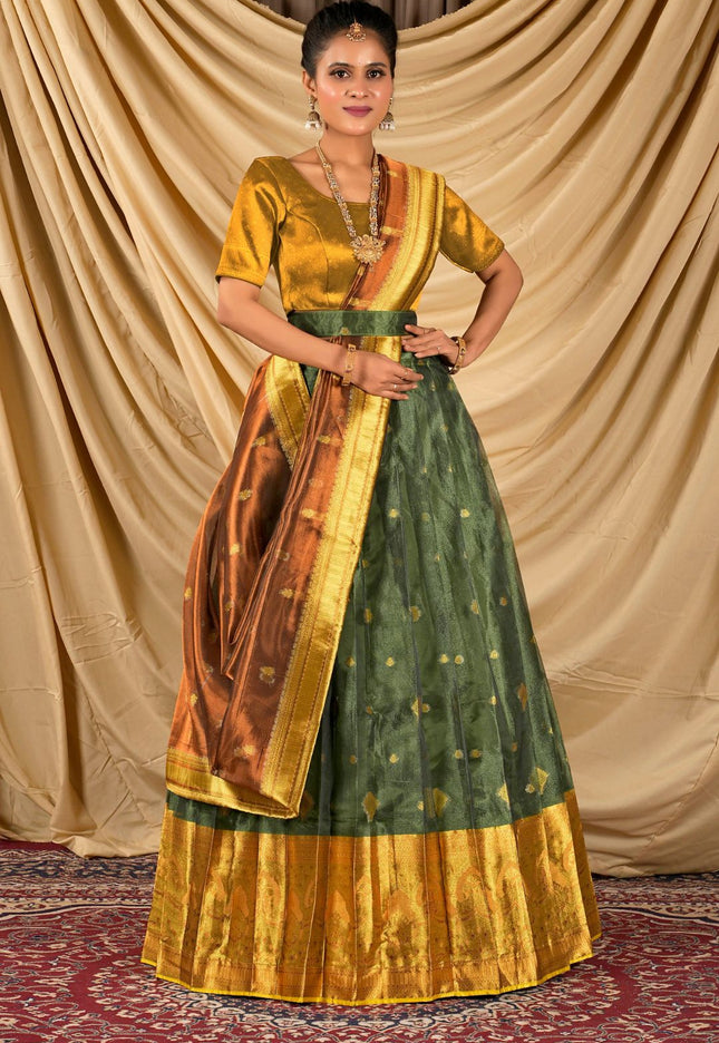 Woman wearing a traditional green and gold lehenga choli with dupatta