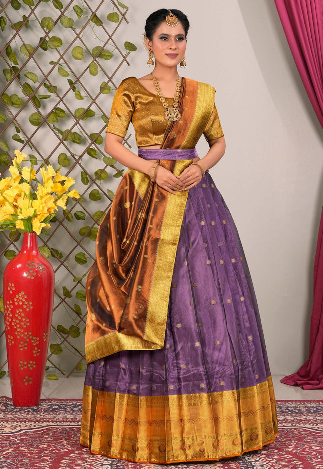 Woman wearing a traditional lehenga with a gold and purple design 