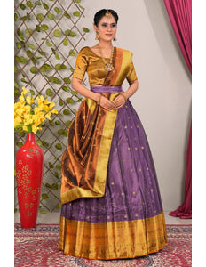Woman wearing a traditional lehenga with a gold and purple design 