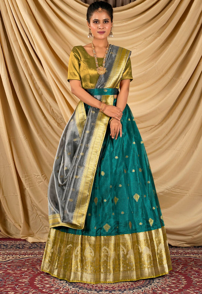 Woman wearing a traditional green and gold lehenga choli with dupatta
