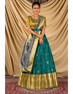 Woman wearing a traditional green and gold lehenga choli with dupatta