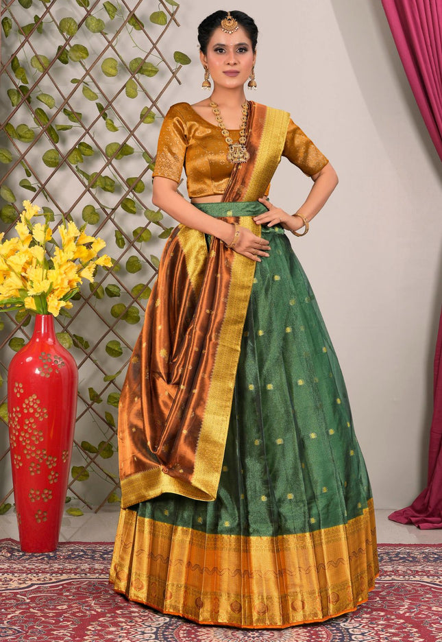 Woman wearing a traditional green and gold lehenga choli with dupatta