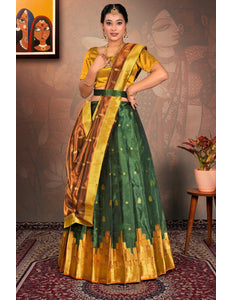 Woman in a green and gold traditional lehenga choli with dupatta