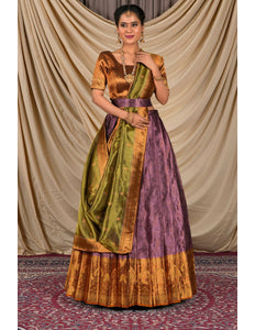Woman wearing a traditional outfit with a gold, green, and purple lehenga choli with dupatta