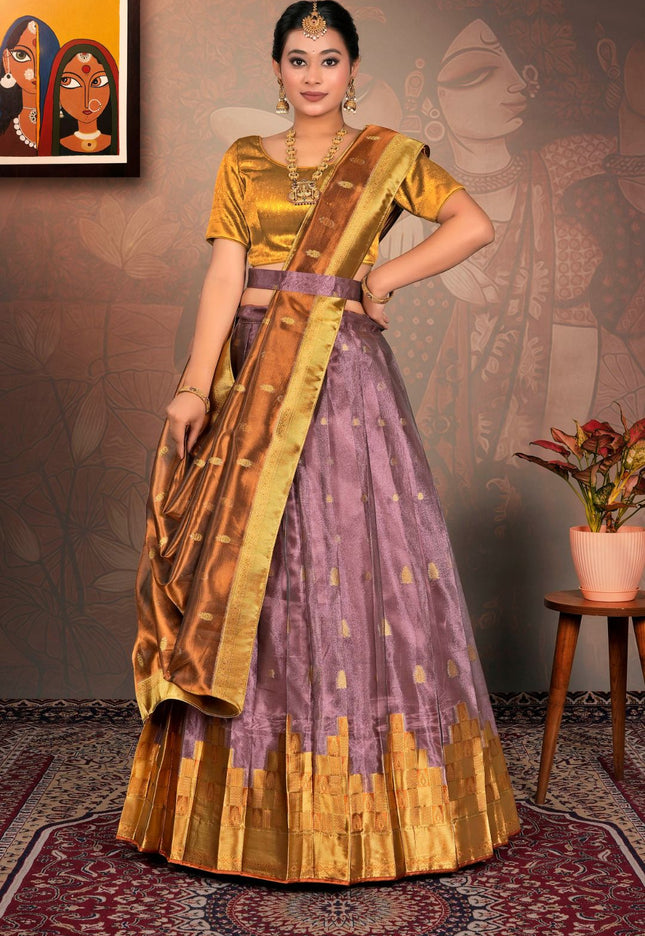 Woman wearing a traditional gold and purple lehenga choli and dupatta